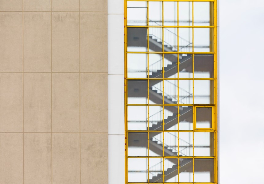 A yellow and white window with stairs in the window.