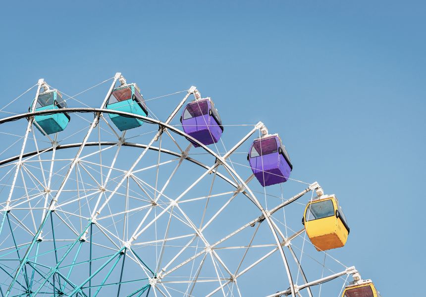 A ferris wheel with colorful cabins