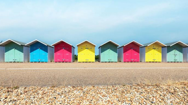 Image of eight small houses with difference colors across the road